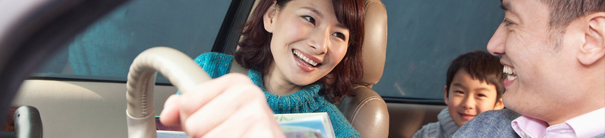 Immigrant family sitting in a car with a salesman